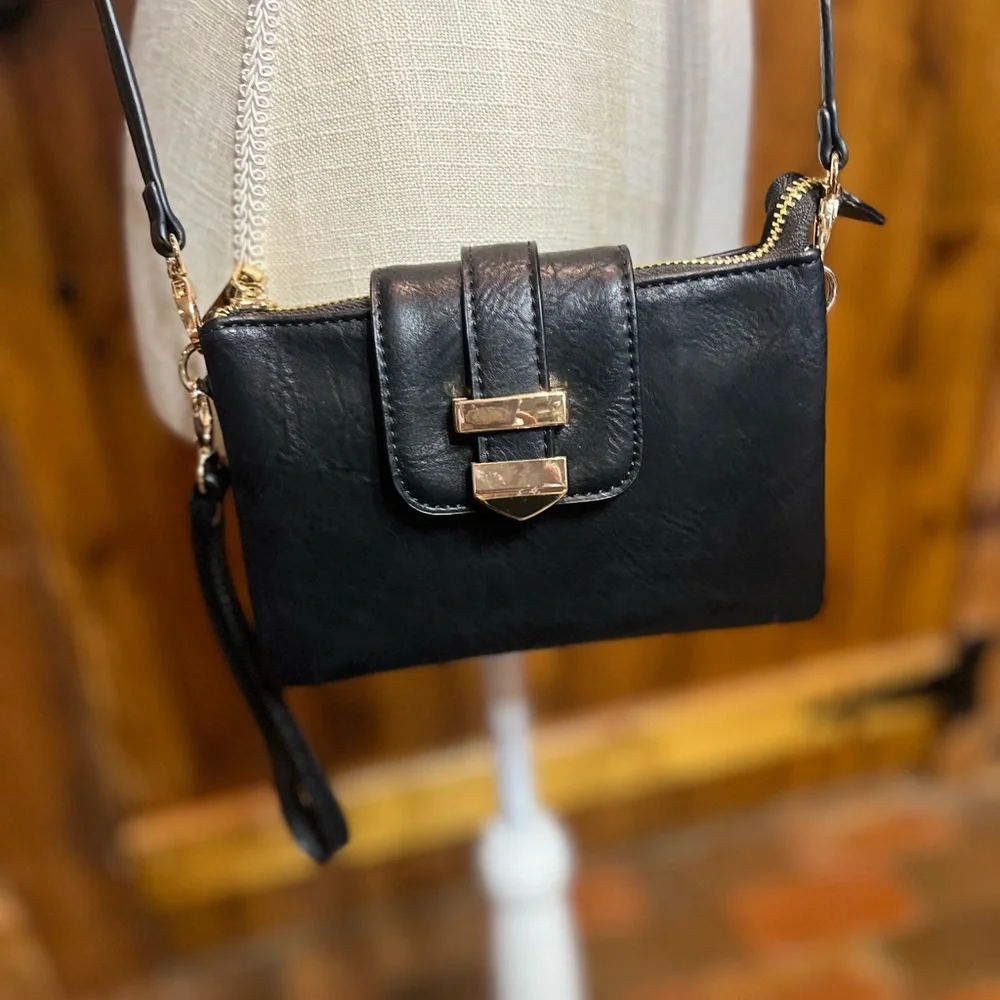 Madison West black wristlet 5 inches high by 7 inches wide with shoulder strap